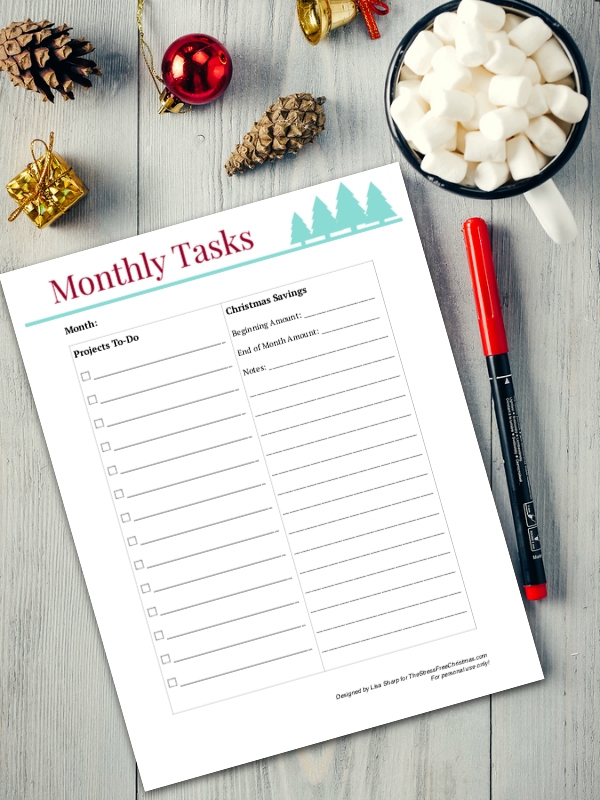 monthly task list, mug hot chocolate with marshmallows, New Year's decoration and pine cone on gray wooden background