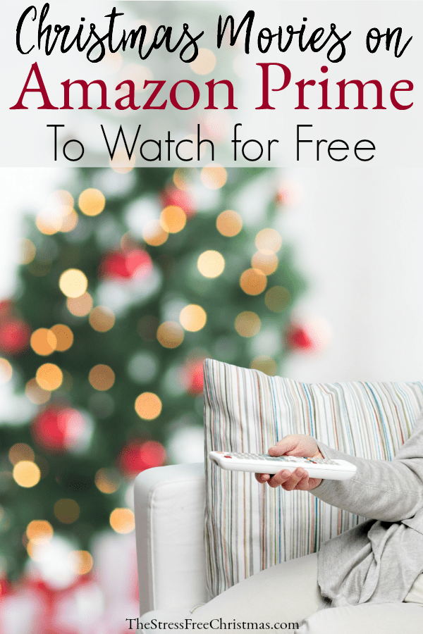 Person on sofa with remote with Christmas tree in background