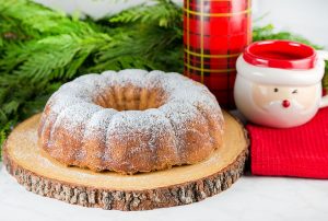 lemon ricotta amaretti bundt cake on platter with christmas decor