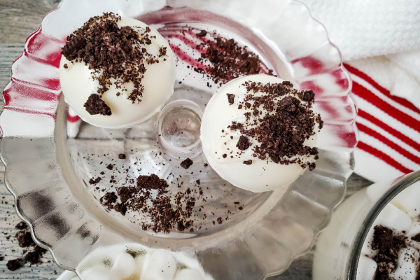 two Oreo hot cocoa bombs on glass plate