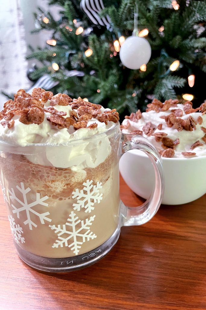 cereal milk whipped cream in bowl and mug of hot chocolate in front of Christmas tree