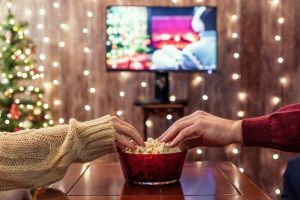 couple eating popcorn and watching Christmas movies