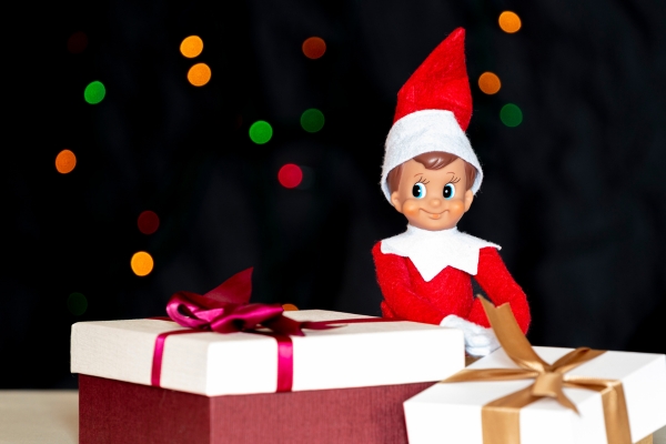 elf on the shelf sitting by presents