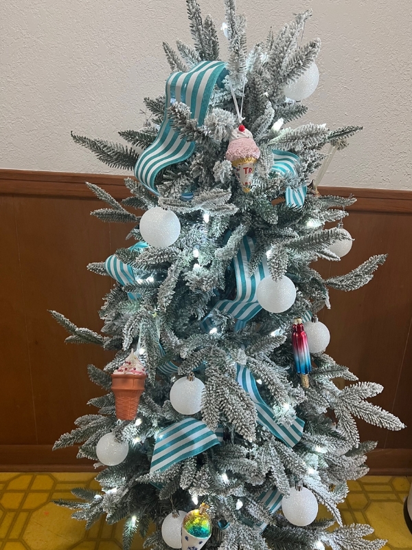 small christmas tree with ice cream themed ornaments and blue and white ribbon