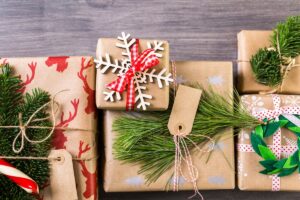 christmas gifts in brown paper with green and red