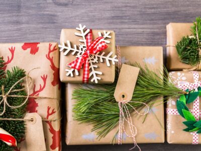christmas gifts in brown paper with green and red