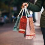 person holding christmas shopping bags