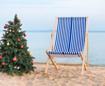 christmas tree and beach chair on beach